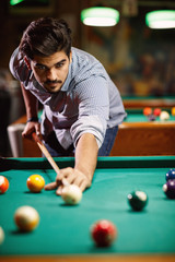 billiard game- young man playing snooker.