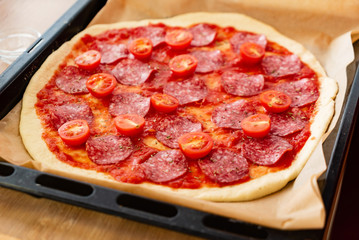 Pepperoni Pizza with Mozzarella cheese, salami, Tomatoes, pepper.