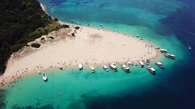 Aerial drone video from famous for Caretta caretta sea turtle haching, exotic small island of Marathonisi with white caves and sapphire sea and sandy beach , Zakynthos island, Ionian, Greece