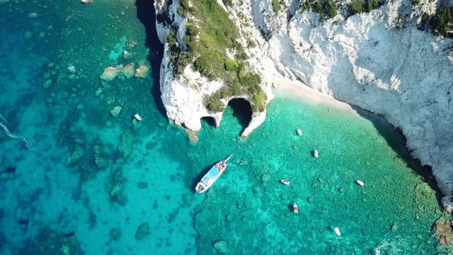 Aerial drone video of famous white caves in small island of Marathonisi and beautiful turquoise seascape, Zakynthos island, Ionian, Greece