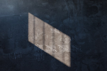 3d rendering of grunge prison cell wall with the shadows of stanchions projected on wall with scratched lines and words