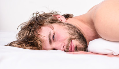 Fototapeta na wymiar Guy bearded macho relax in morning. Man attractive macho relax and feel comfortable. Simple tips to improve your sleep. Total relax concept. Man unshaven bearded face sleep relax or just wake up