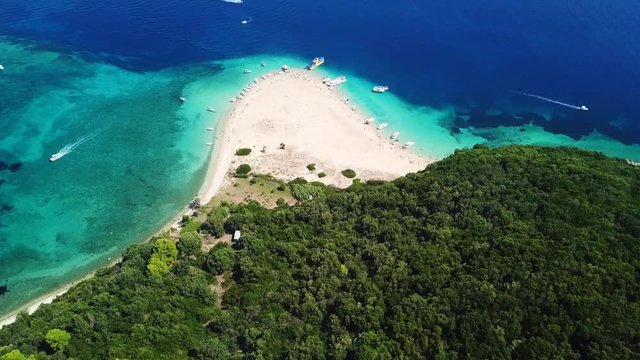 Aerial drone video from famous for Caretta caretta sea turtle haching, exotic small island of Marathonisi with white caves and sapphire sea and sandy beach , Zakynthos island, Ionian, Greece