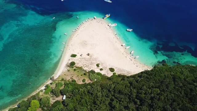 Aerial drone video from famous for Caretta caretta sea turtle haching, exotic small island of Marathonisi with white caves and sapphire sea and sandy beach , Zakynthos island, Ionian, Greece