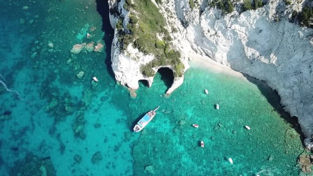 Aerial drone video from famous for Caretta caretta sea turtle haching, exotic small island of Marathonisi with white caves and sapphire sea and sandy beach , Zakynthos island, Ionian, Greece