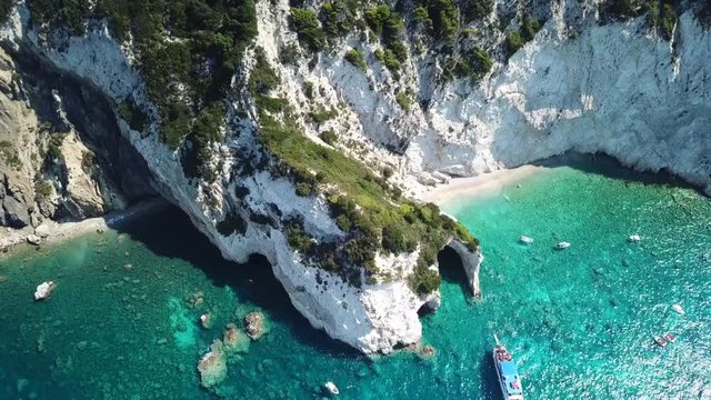 Aerial drone video from famous for Caretta caretta sea turtle haching, exotic small island of Marathonisi with white caves and sapphire sea and sandy beach , Zakynthos island, Ionian, Greece