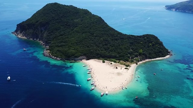 Aerial drone video of tropical island with volcanic caves and exotic emerald sea colour sandy beaches