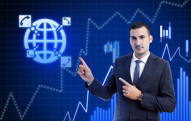 Business man pointing at phone and globe symbols .