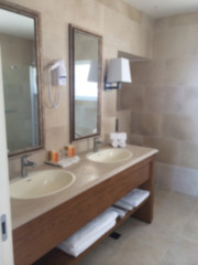 Fototapeta na wymiar Blur interior design, bathroom closeup, marble sink, mirror, lamps and accessories