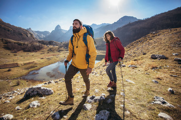 Group of hikers walking on a mountain at autumn day