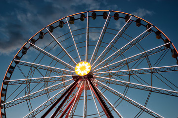 Fototapeta premium attraction Ferris wheel against a background of evening dark blue sky with clouds