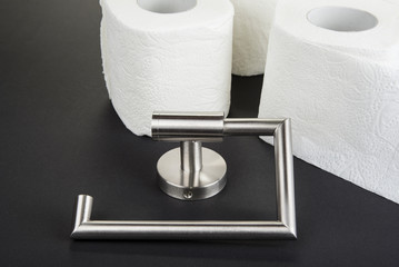 Toilet paper holder isolated on the black