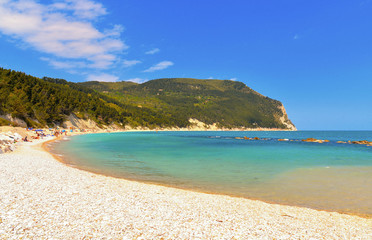 seascape, paradise beach with people and natural summer landscape view from Sirolo Marche, Italy