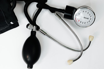 Cardiology. Tonometer and a manometer, stethoscope for diagnosis to measure of blood pressure and pulse, on a white background.