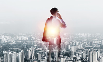 Concept of business success and control with confident boss against cityscape background