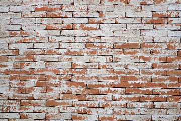 Background of old vintage brick wall with peeling white, texture.