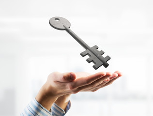 Concept of success and apartments presented by stone symbol in male palms. Mixed media