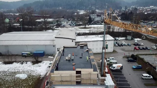 Construction crane and hydroisolation at a building rooftop