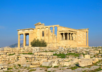 Athens Acropolis, Detail of Erectheion temple with caryatids and panoramic view of the Athens in background, Greece                    