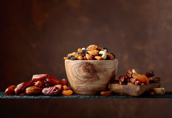 Various dried fruits and nuts in wooden dish.