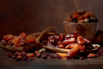 Various dried fruits and nuts in wooden dish.