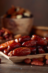 Various dried fruits and nuts in wooden dish.