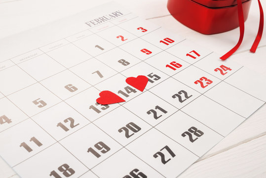  February calendar with red hearts on 14 February and gift box
