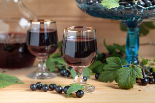 Homemade black currant liqueur and fresh berries .