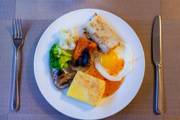breakfast with crispy bacon, eggs, pancakes, toast, coffee, and orange juice.