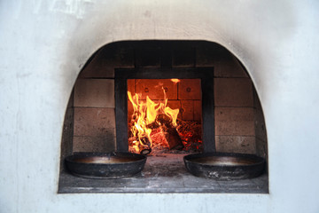 Stone Pizza Oven. Home outdoor stone pizza oven. Traditional pizza production. Preparation of dinner.