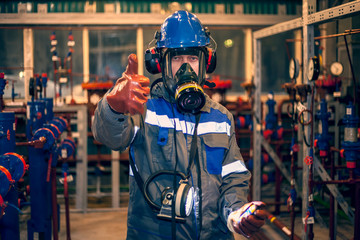 Means of protection against harmful substances, control of the gas pollution of oil and gas equipment, the operator in a gas mask measures hazardous substances. Oil, gas industry,gas conditioning