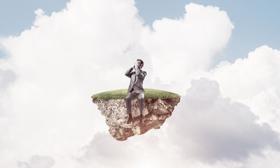 Young man on floating island in blue sky do not want to see anything