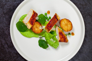 Roast chicken with fondant potatoes and pea mousse