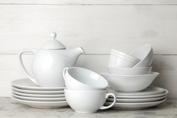 a lot of different dishes. Dinnerware. on a light concrete background. dishes for serving the...