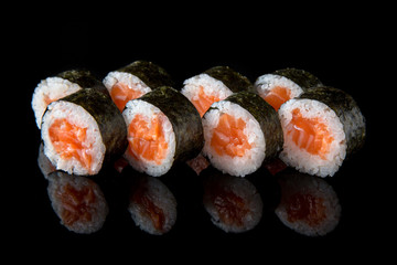 Maki Sushi Rolls with salmon and cheese on black background. Sushi menu. Japanese food.  © Екатерина