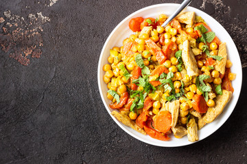 Curry with chickpea, turkey, carrot, leek and dried apricots in a white plate. Healthy food....