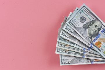 Dollars. American paper money on a pink background