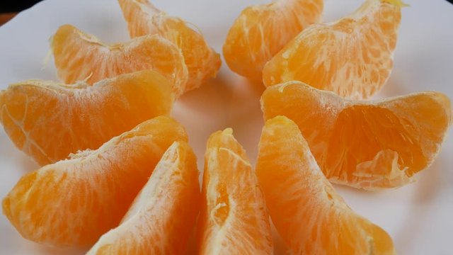 Tangerines or mandarin orange fruits and peeled segment.