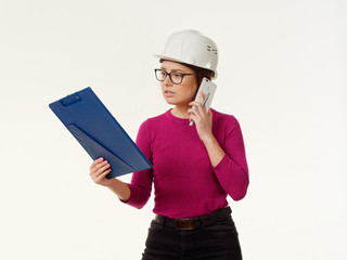 emotional girl foreman in a helmet on a white background.