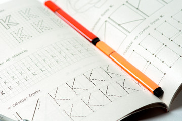 two markers are in a notebook for writing, coloring