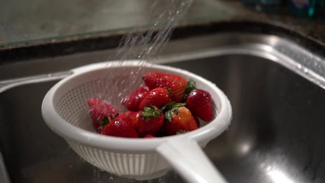 Washing strawberries in a strainer. Shot on Batis 25mm on a Sony A7iii and slowed to 25%.