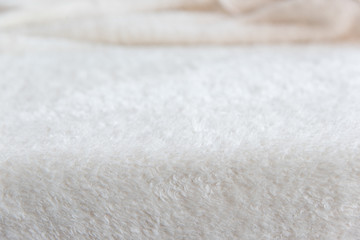 Fototapeta na wymiar Blurred background of soft tissue. Beige background of plush fabric 