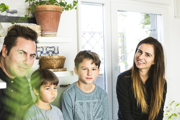 Portrait of a happy family kissing and hugging at home. Family lifestyle showing affection