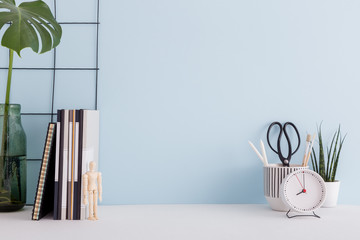 Office desk with supplies, and blue wall mock up.