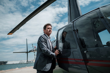 Businessman entering his private helicopter