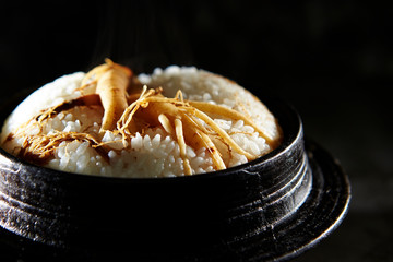 Ginseng root on steamed rice in pot 