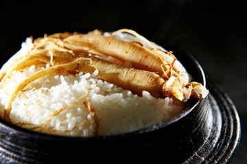 Ginseng root on steamed rice in pot 