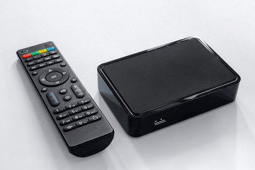 Iptv box and remote controller. Modern multimedia device for viewing television via the Internet,...