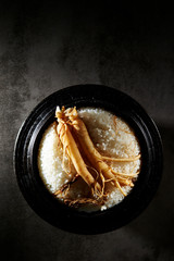 Ginseng root on steamed rice in pot 