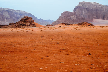 Red mountains of the canyon of Wadi Rum desert in Jordan. Wadi Rum also known as The Valley of the Moon is a valley cut into the sandstone and granite rock in southern Jordan to the east of Aqaba.